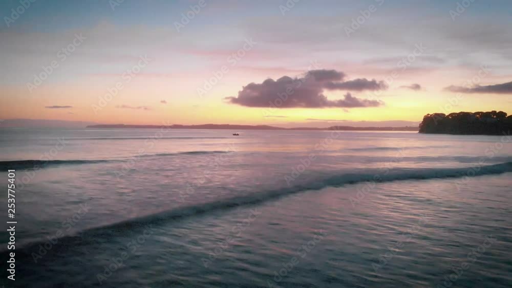 Row boat out at sea during sunset in New Zealand Row boat out at sea during sunset in New Zealand