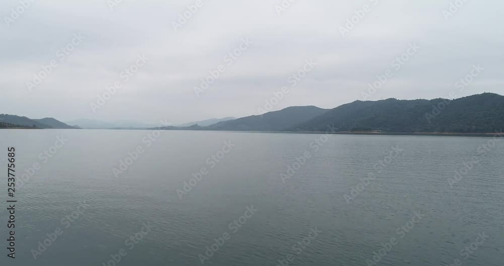aerial view of calm lake on cloudy day aerial view of calm lake on cloudy day