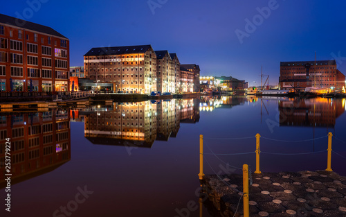 Gloucester docks on sharpness canal. Warehouse apartments reflected in quay water