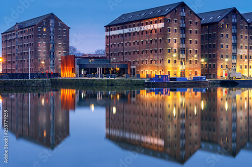Obraz na plátně Gloucester docks warehouses reflected in quay on Sharpness Canal