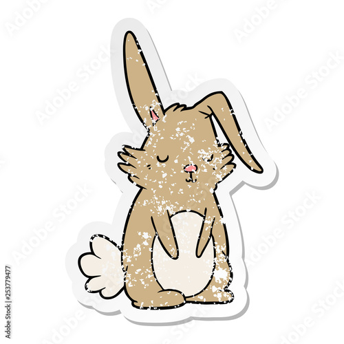 distressed sticker of a cartoon sleepy rabbit