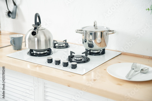 Metal kettle and saucepan on the stove