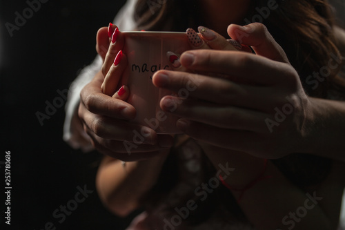 unrecognizable man and woman hold with two hands a mug of hot coffee. Couple in love. Love care concept. © Andrii