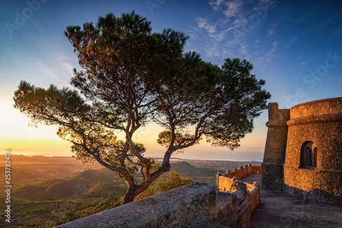 San Salvador Mallorca at sunrise. Lone tree near monument. Cycling destination at the top of hill
