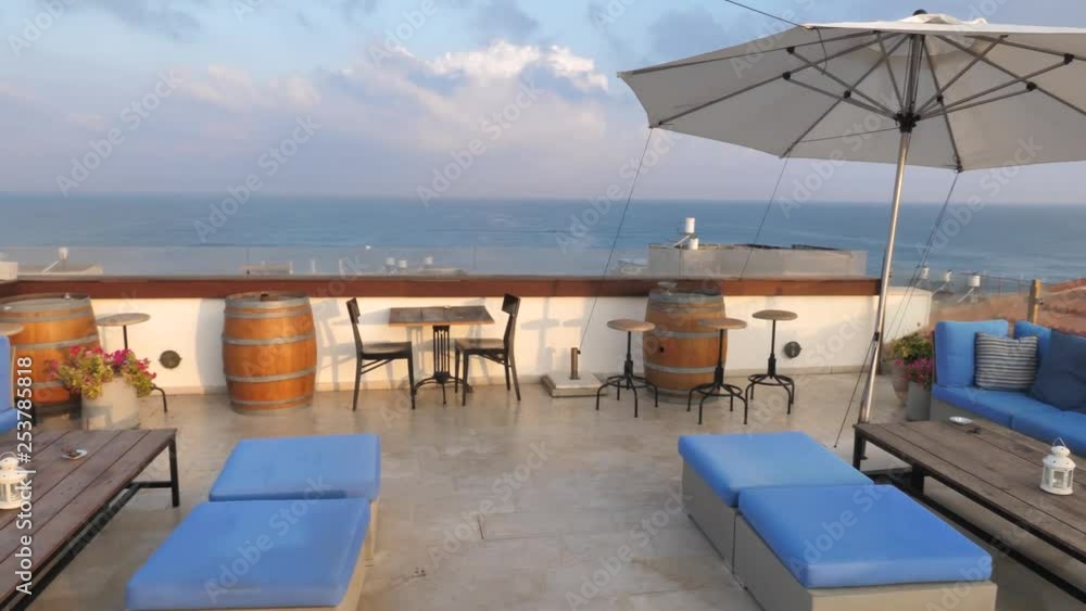 Panning view of terrace on rooftop in Acre with open sea in background Panning view of terrace on rooftop in Acre with open sea in background