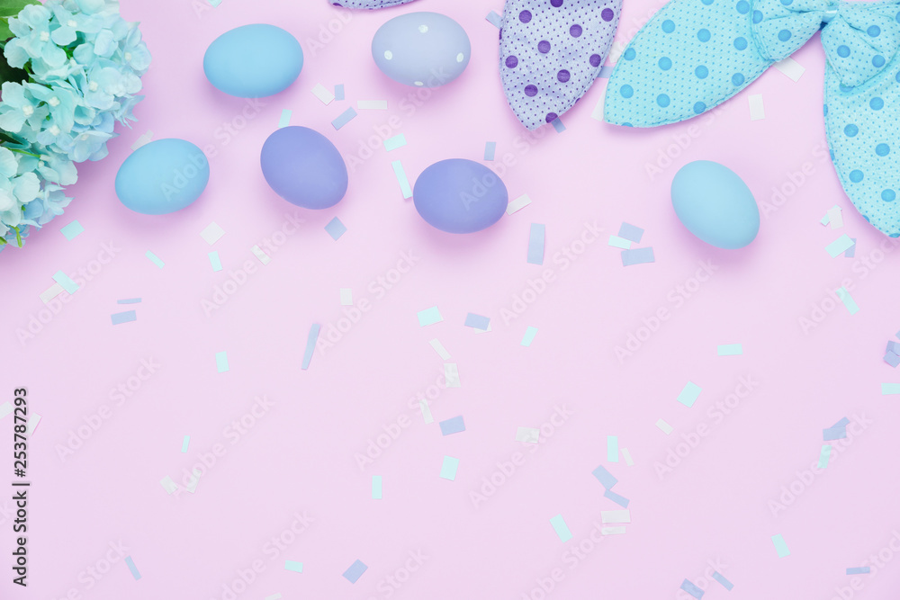 Table top view shot of decorations Happy Easter holiday background concept.Flat lay  eggs with cute bunny ear & confetti on modern rustic pink paper.Blank space creative design for mock up & template.
