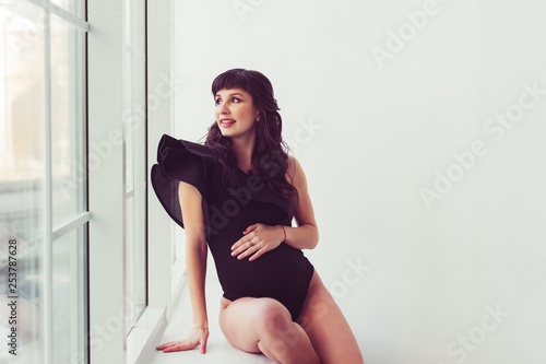 Pregnant girl looks out the window