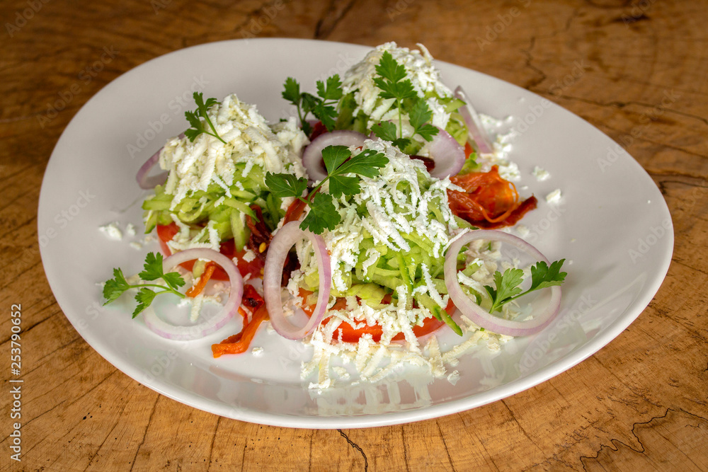 Salad with tomatoes, grated cucumbers, onion, garlic, roasted red pepper, white cow cheese and parsley. Salad with tomatoes, grated cucumbers, onion, garlic, roasted red pepper, white cow cheese and parsley.