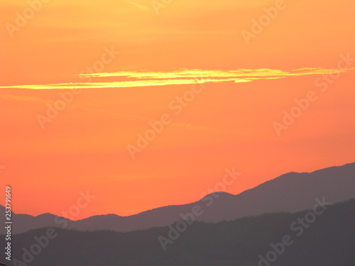 Orange sky and cloud at sunset over a mountain range near Tirana, Albania