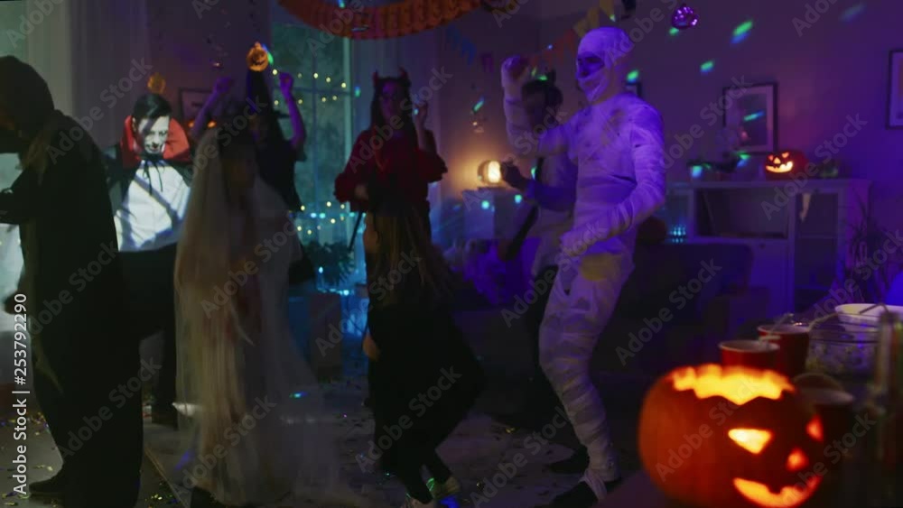 Halloween Costume Party:Group of Young Monsters Dancing and Having Fun in Decorated Room with Disco Lights. Zombie, Blood Thirsty Dracula, Mummy, Bewitching Witch, Dazzling She Devil and Little Bat Halloween Costume Party:Group of Young Monsters Dancing and Having Fun in Decorated Room with Disco Lights. Zombie, Blood Thirsty Dracula, Mummy, Bewitching Witch, Dazzling She Devil and Little Bat