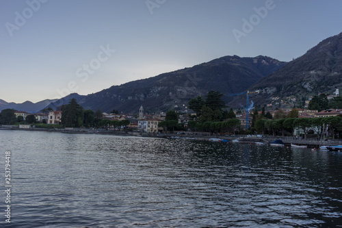 Italy, Lecco, Lake Como, a body of water with a mountain in the background