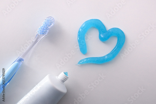 Dental health concept with toothbrush tube and toothpaste heart detail