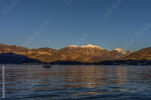 Italy, Lecco, Lake Como, a large body of water with a mountain in the background