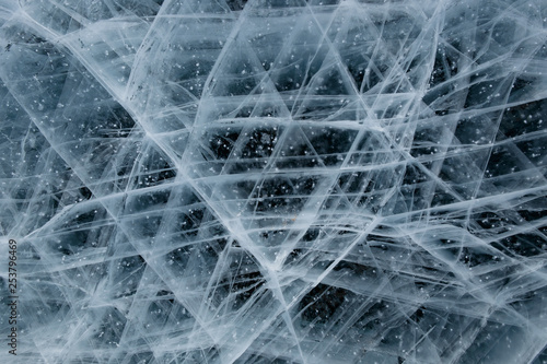 Fototapeta Naklejka Na Ścianę i Meble -  Grid of white cracks of ice of Baikal, suitable for a background or wallpaper of your design.