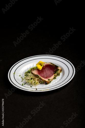 Tuna appetizer on black background