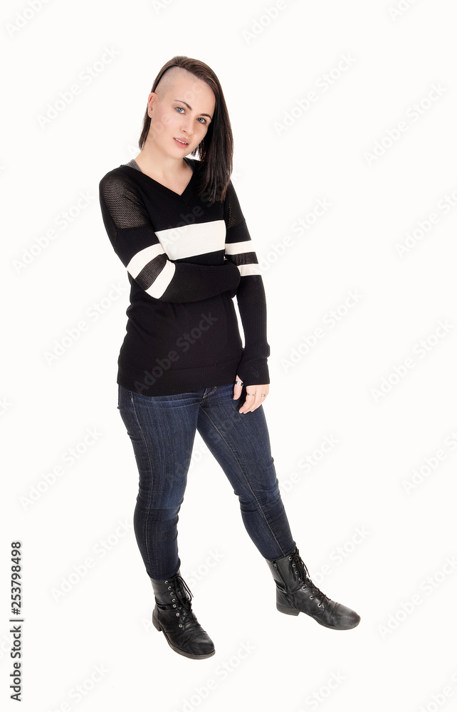 Pretty young woman standing in jeans and sweater Pretty young woman standing in jeans and sweater