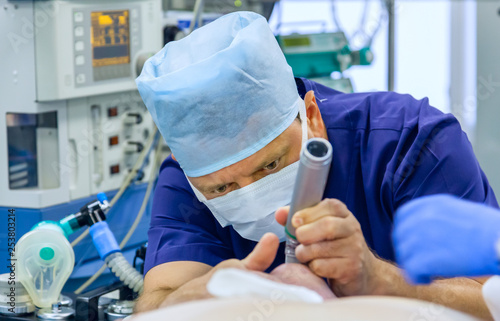 Anesthesiologist performing tracheal intubation photo