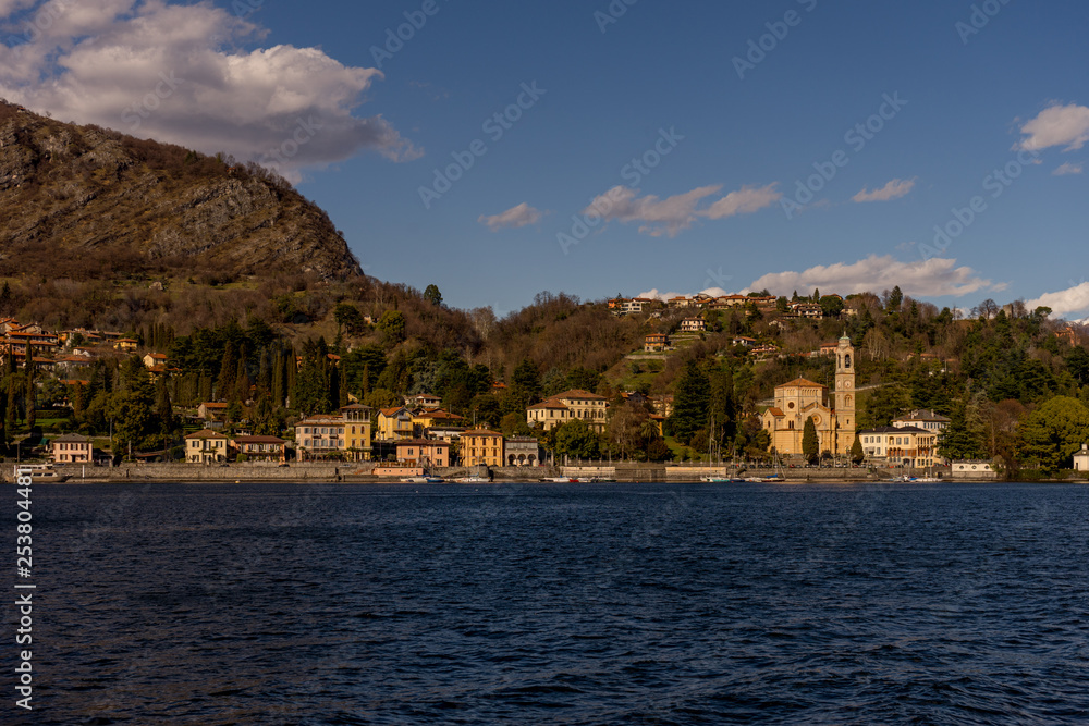 Naklejka premium Italy, Lecco, Church clock tower overlooking Lake Como