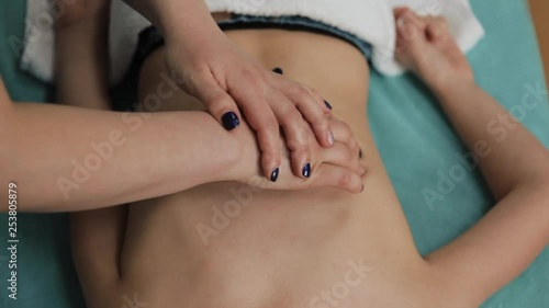 Wallpaper Mural Alternative medicine treatment. Little girl osteopath doing back massage. A professional masseuse does a back massage for a little girl in the spa salon Torontodigital.ca