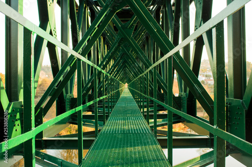 Fotografie Metal structure of railway bridge, railway with vanishing point in the center