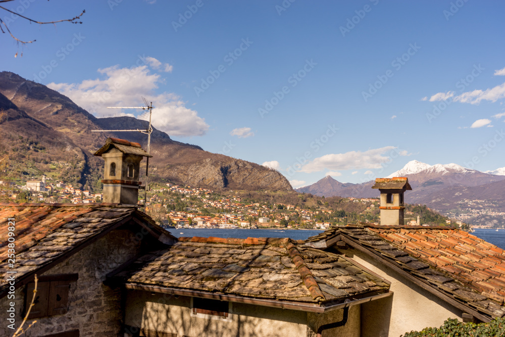 Italy, Lecco, Lake Como, a view of a stone building with a mountain in the background