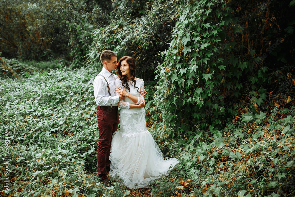 stylish bride and groom in the garden. rustic style stylish bride and groom in the garden. rustic style