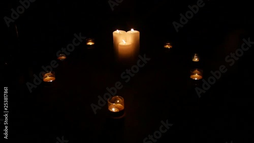 A circle of candles in the dark
