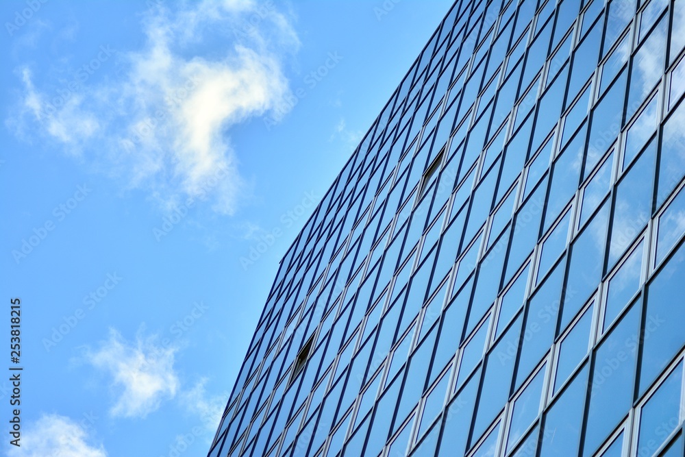 Surface of glass building with the reflection of clouds Surface of glass building with the reflection of clouds