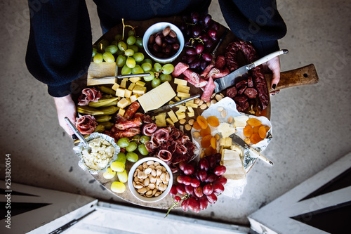 Charcuterie, Cheese and Fruit platter on wooden cutting board photo