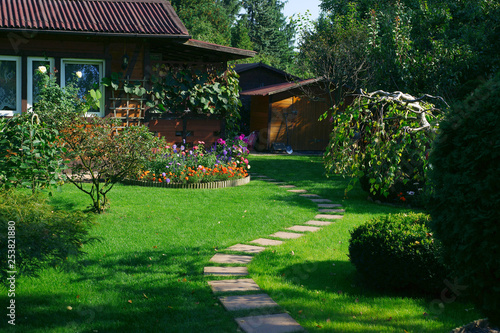 Beautiful lawn and path in a flowering garden