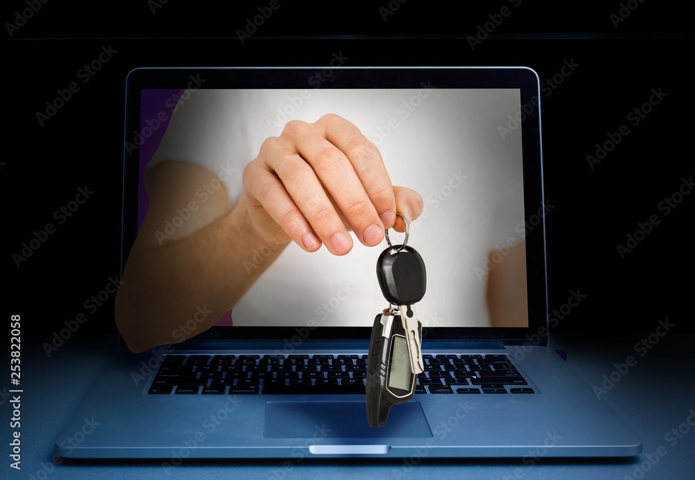 Hand with huge vintage key coming out of a laptop with sparkling