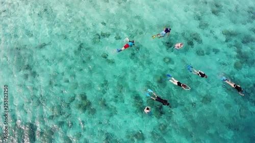 Snorkelers explore reef in Seychelles photo