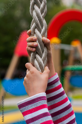 Сhild holds the rope. Platform for workout. 