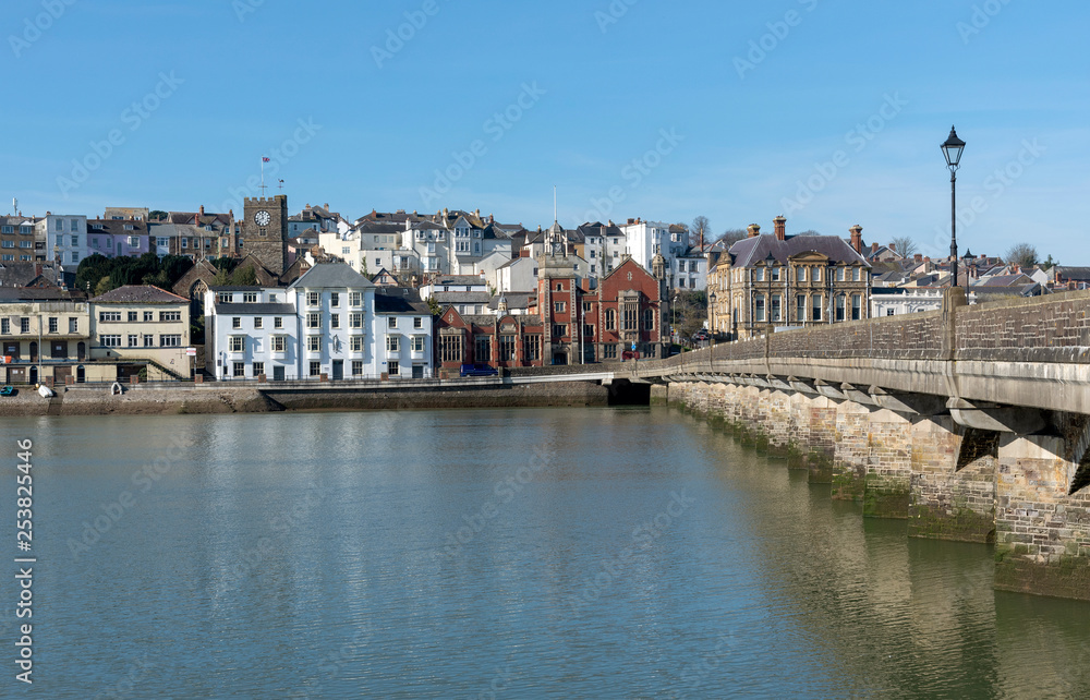 Fototapeta premium Bideford, North Devon, England UK. March 2019. Bideford town and the Bideford Long bridge built in 1850 viewed from East the Water.
