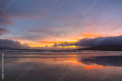 Colorful Sunset and moon in the sky over Beach in County Mayo Mulranny Ireland