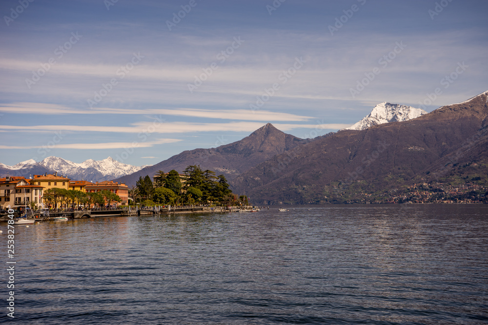 Italy, Menaggio, Lake Como, a large body of water with a mountain in the background