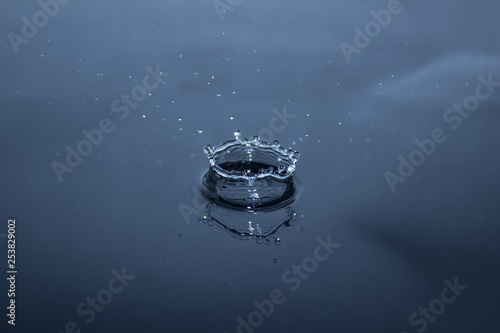 Waterdrop splashing in blue water