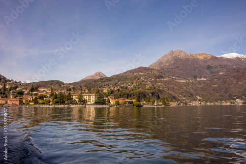 Fototapeta Naklejka Na Ścianę i Meble -  Italy, Menaggio, Lake Como, a body of water with a mountain in the background