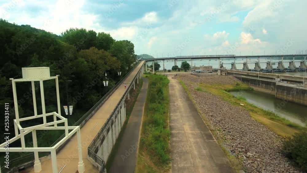 Medium aerial shot along an Arkansas River over-pass and lock and dam, in Little Rock during the day. Medium aerial shot along an Arkansas River over-pass and lock and dam, in Little Rock during the day.