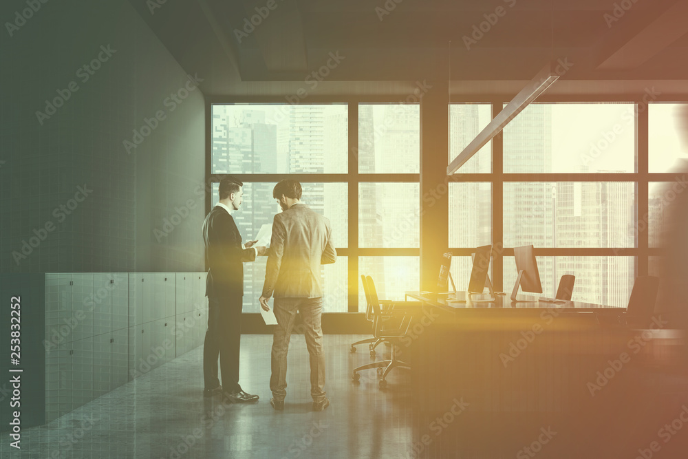 People in gray open space office with closet People in gray open space office with closet
