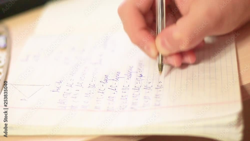 a teenager with close-up writing in a notebook a teenager with close-up writing in a notebook