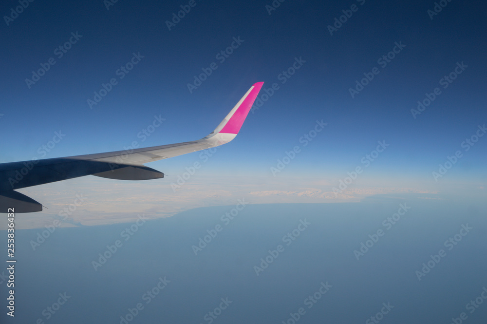 Aerial View of Iceland Coastline with Wing of Plane in Flight Aerial View of Iceland Coastline with Wing of Plane in Flight