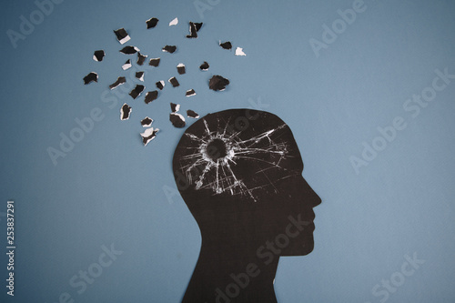 Brain disorder symbol presented by human head made form paper . Creative idea for Alzheimer's disease, dementia, memory loss and mental health concept.