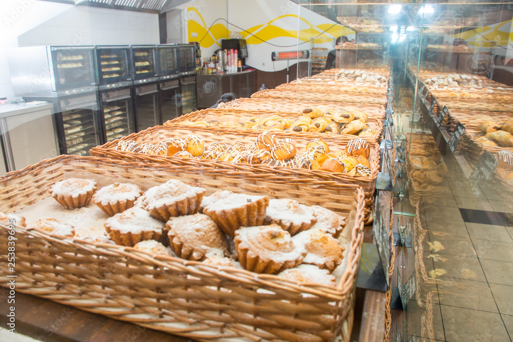 bakery products on display against the background of ovens in the bakery
