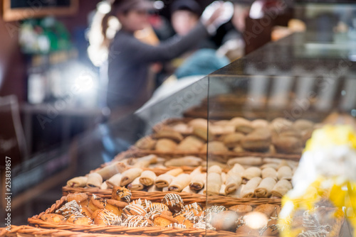 bakery products on display against the background of ovens in the bakery