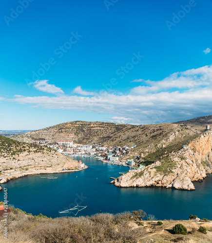 Balaklava bay in Crimea, mountain cliffs and sea port with ships. Beautiful nature panorama landscape, town among hills and black sea coast. Summer travel concept