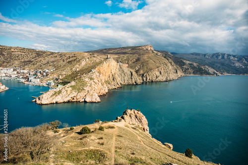 Balaklava bay in Crimea, mountain cliffs and sea port with ships. Beautiful nature panorama landscape, town among hills and black sea coast. Summer travel concept