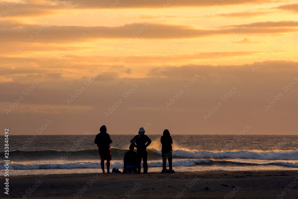 People enjoying the sunset at the beach