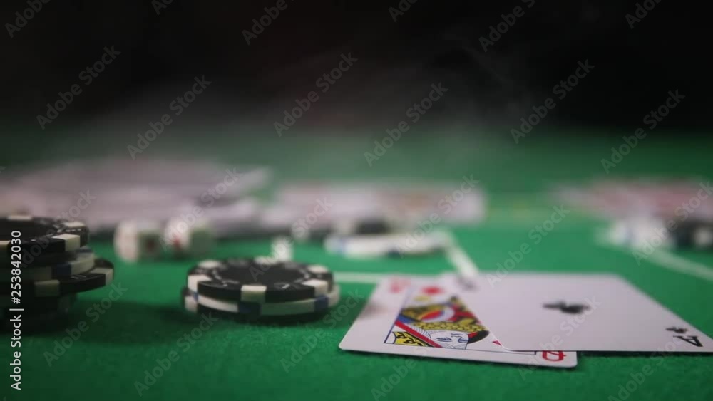 Cards and chips on green felt casino table. Abstract background with copy space. Gambling, poker, casino and cards games theme. Casino elements on green. Selective focus Cards and chips on green felt casino table. Abstract background with copy space. Gambling, poker, casino and cards games theme. Casino elements on green. Selective focus
