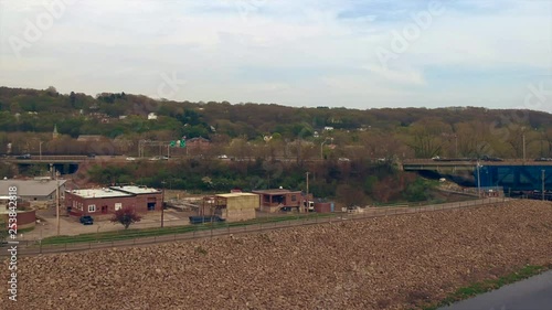 Drone hovering over a river with a highway in the background photo